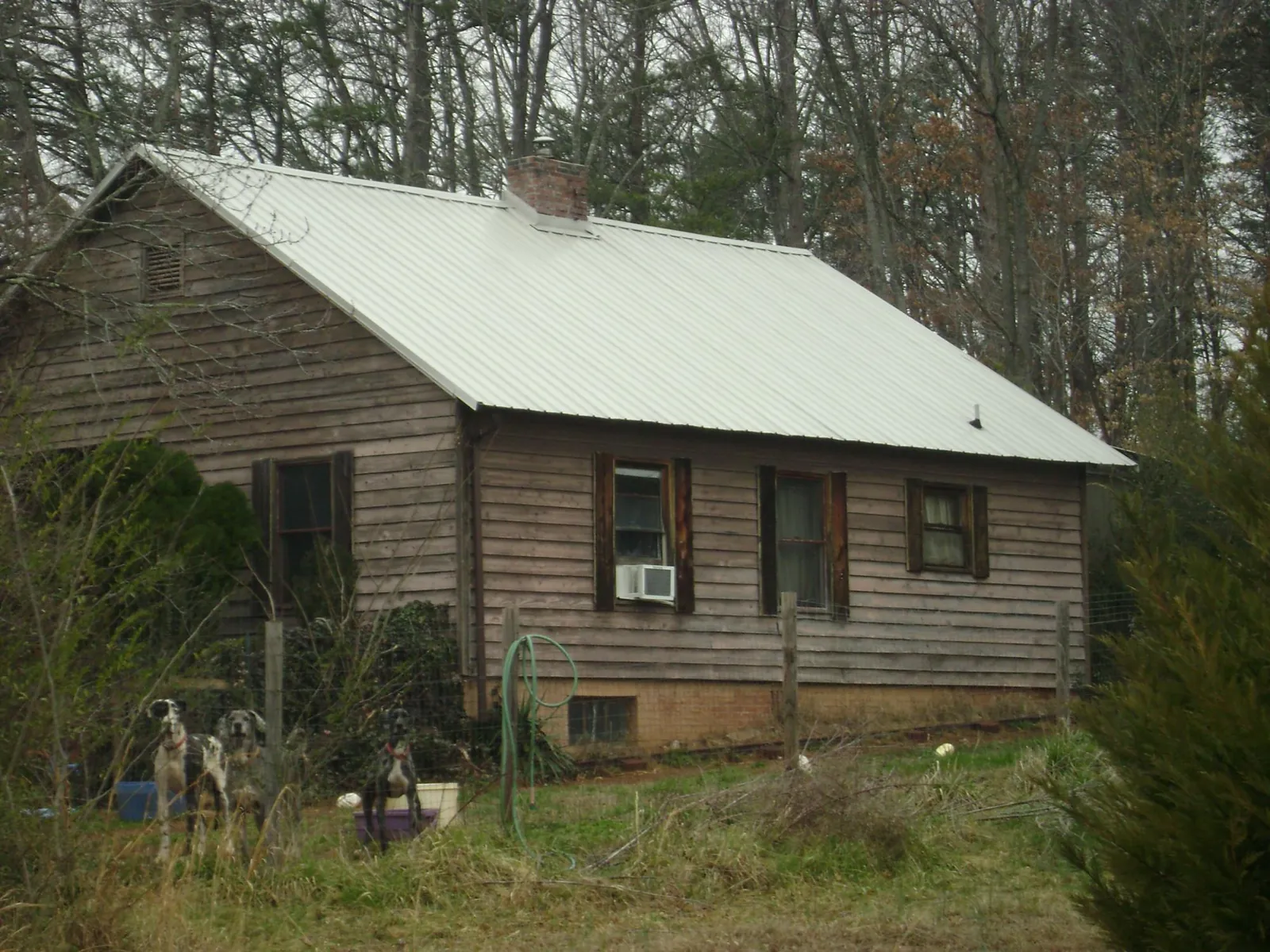 White metal roof on an old wood sided farmhouse, from a Metal Roof Installation job in New Braintree